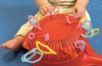 Easy toddler activities with pipe cleaner using a simple colander.