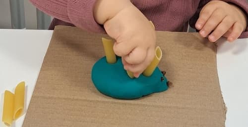 easy playdough activity for toddlers using pasta to build fine motor skills