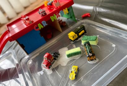This easy car wash sensory bin uses soapy water, toy cars, and sponges to build fine motor skills, hand strength, and imaginative play. Perfect for car-loving toddlers at home