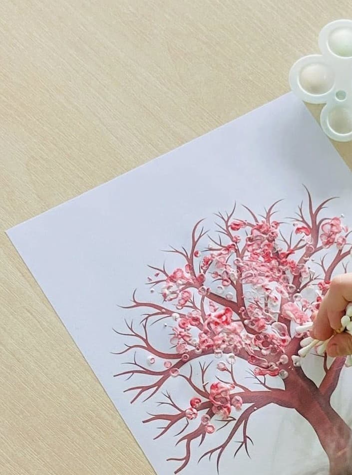 cherry blossom painting for toddlers uses Q-tips to create beautiful flowers with simple stamping