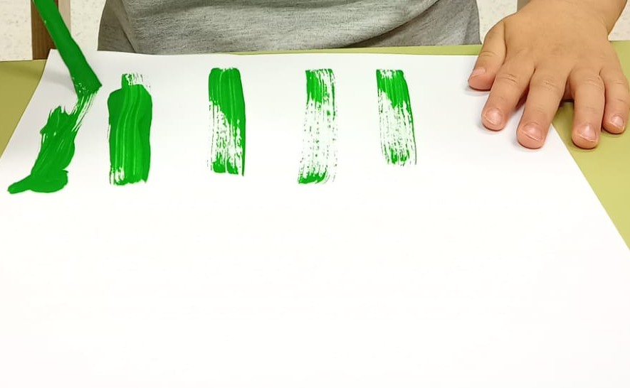 toddler fork painting flowers activity with green stems and colorful paint