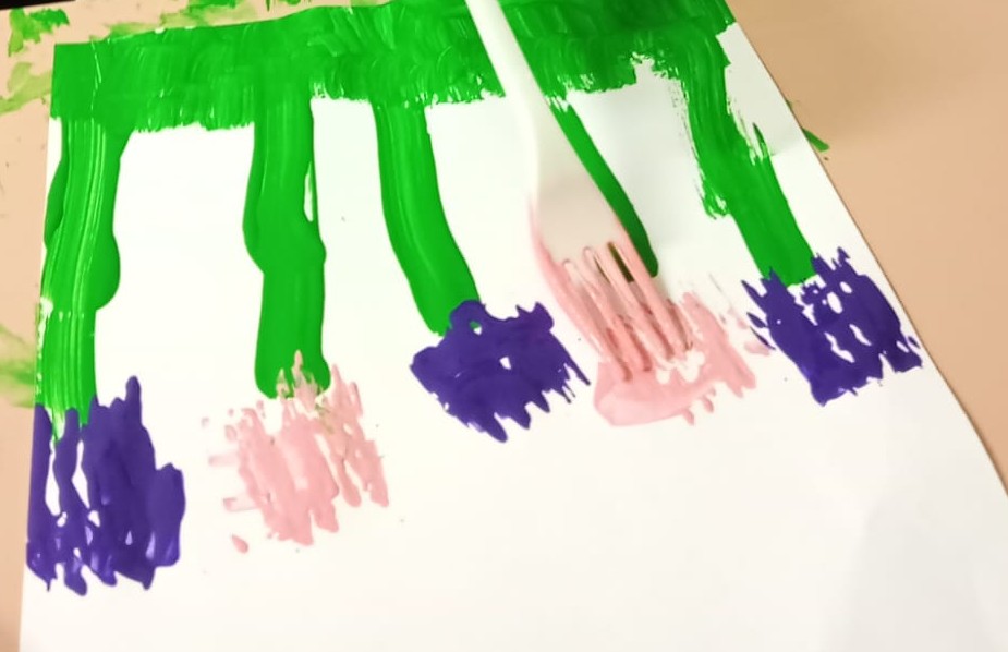 toddler fork painting flowers activity with green stems and colorful paint