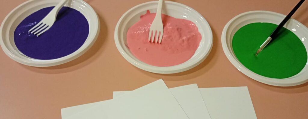 toddler fork painting flowers activity with green stems and colorful paint