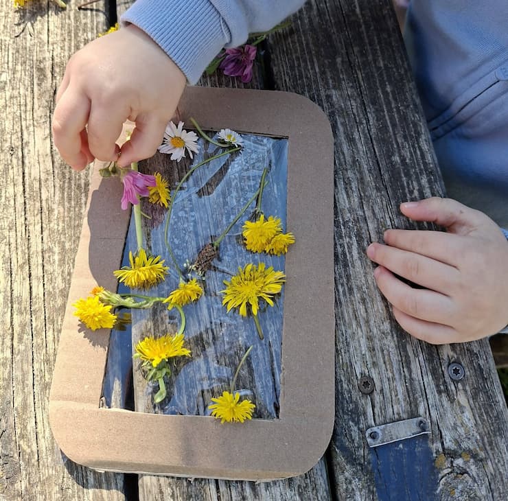 Toddler making flower suncatcher craft