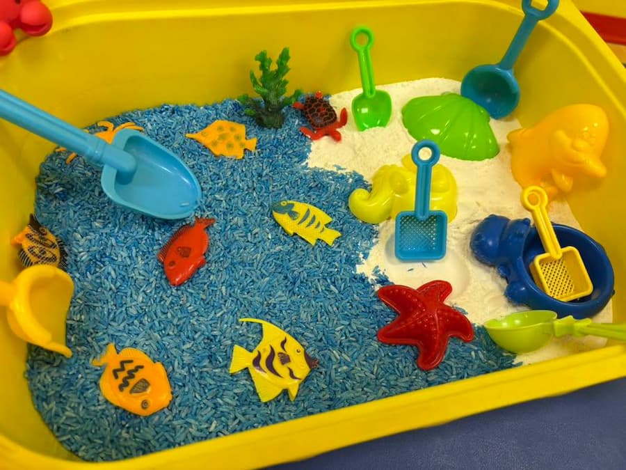 Ocean Sensory Bin with Blue Rice and White Flour