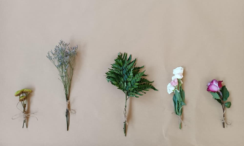 Tie flowers and leaves onto a stick to create a beautiful nature paintbrush.
